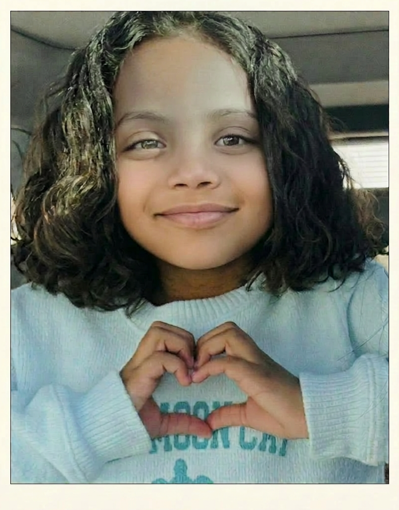 Marley making a heart with her hands